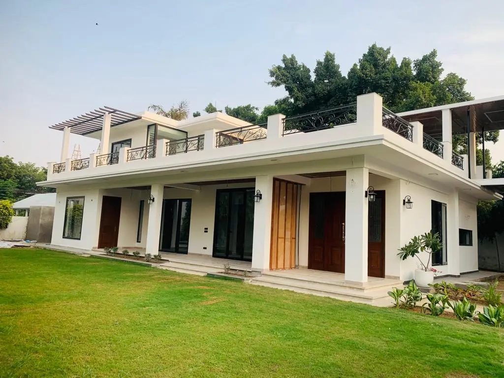 Image of Luxurious farm house in Delhi NCR with modern amenities, surrounded by lush greenery.